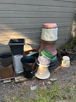stacked assortment of planters against wall