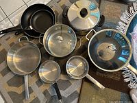 All pots, pans, and lids laid out