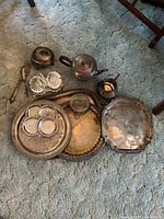 Group shot of all silver-plated items on carpet