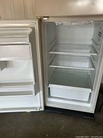Interior view of refrigerator compartment with shelves and crisper