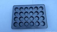 Top view of 24-cup muffin pan showing cup arrangement and surface