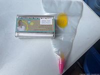 Kit box beside clear piping bag with coupler