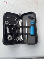 Open pouch showing tools secured by elastic straps