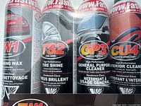 Front view of four shrink-wrapped FW1 aerosol cans showing product codes and labels