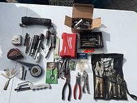 Overview of entire lot on table showing mix of tools and accessories