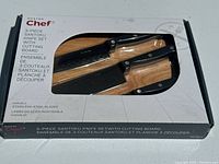 Front of sealed Master Chef box showing knives and board