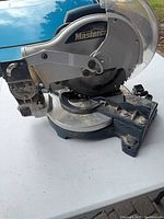 Left side view of Mastercraft miter saw showing blade guard, motor housing and base