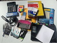 Overview of all items: sheet protectors box, labels, calculator, sticky flags, mouse, adapters, notebook, folder, pouch