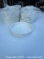 Stacks of white ceramic quiche or tart baking dishes