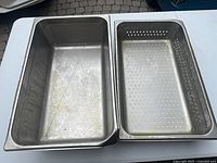 Top view of solid pan and perforated insert side by side