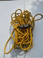 Coiled yellow extension cord showing in-line GFCI module