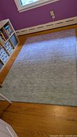 Full view of Addison chenille rug on hardwood floor