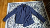 Front view of navy Banana Republic jacket laid flat