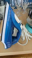 Left side view of Blue/White Black+Decker steam iron with cord
