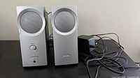 Front view of both Bose Companion 2 speakers with power adapter and cables visible