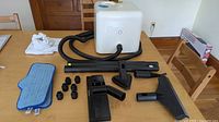 All components on table including main unit, hose, attachments, cloths