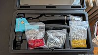 Open case showing rivet gun and three bags of rivets