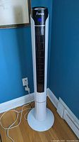 Full view of iFanze tower fan standing on base with cord