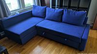 Sofa in sectional configuration showing chaise on left and three back cushions