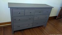 Front view of gray IKEA Hemnes dresser showing eight drawers