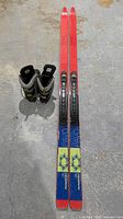Pair of Karhu Pavo skis with Salomon bindings and Karhu boots displayed on floor