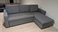 Sofa in couch configuration showing three back cushions, chaise on right