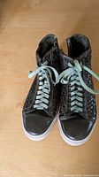Pair of dark green woven leather high-top sneakers from above
