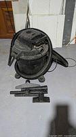Overall view of Sears wet/dry shop vacuum with hose and three attachments