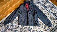 Front view of navy Tommy Hilfiger jacket laid flat showing exterior and pockets