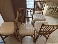 Front view of four bamboo chairs with cushions