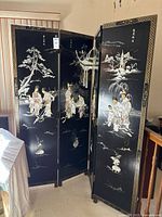 Full view of 4-panel folding screen standing partially open