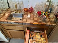 Crystal decanters on counter, carnival butter dish, boxed decanter, sink area