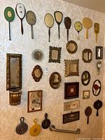 Entire assortment of handheld and wall mirrors mounted on wall