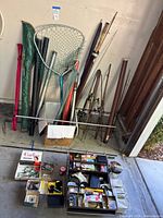 Overall lot showing rods, net, tackle box and rod cases