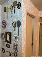 Wall display of hand mirrors and decorative wall mirrors