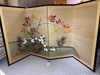 Front view of folded-out four-panel screen showing painted design