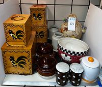 Overview of lot showing rooster boxes, onion soup bowls, mixing bowl, crocks and canister