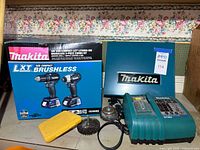 Overall lot: CX200RB combo kit box, teal metal Makita case, charger, battery, wire brushes, yellow case