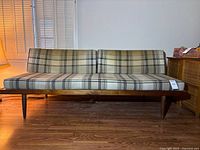 Full front view of sofa on wood floor