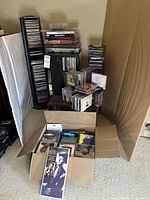 Overall view of CD towers, boxed CDs, and cardboard box filled with CDs