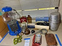 Overall lot with gumball machine, oiler, wrench, hooks, iron box, oil tins, camping stove container