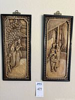 Front view of both carved panels in frames
