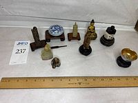 overview of nine miniature items with ruler for scale