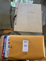 Stamp album and manila envelope containing contents