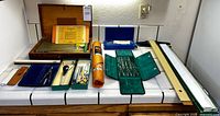 All drafting tool sets, paper roll, rulers, t-square, book displayed