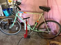 Full view of Peugeot Montreal Express bicycle and red Schwinn floor pump