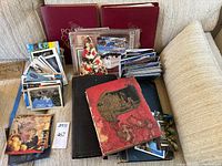 Overview of albums, loose postcard stacks and plastic sleeve