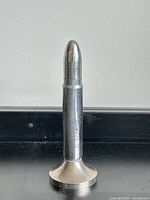 Full view showing bullet lighter on stand