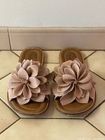 Top view showing both sandals with leather flower details