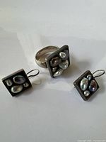 Ring and pair of earrings showing overall design and matching set